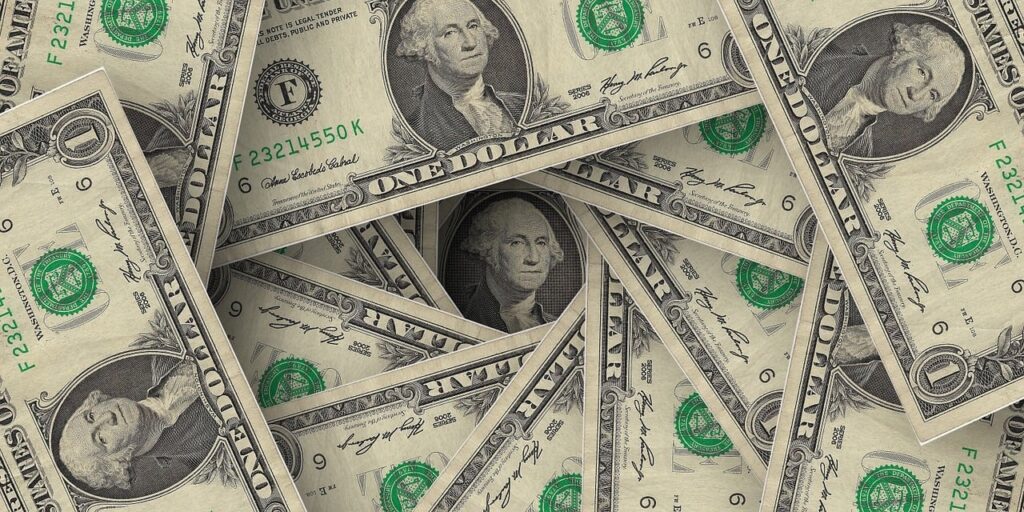 a pile of one dollar bills